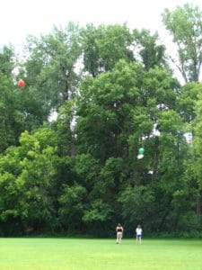 Maggie and Jody with balloons in the air fishing for drones.